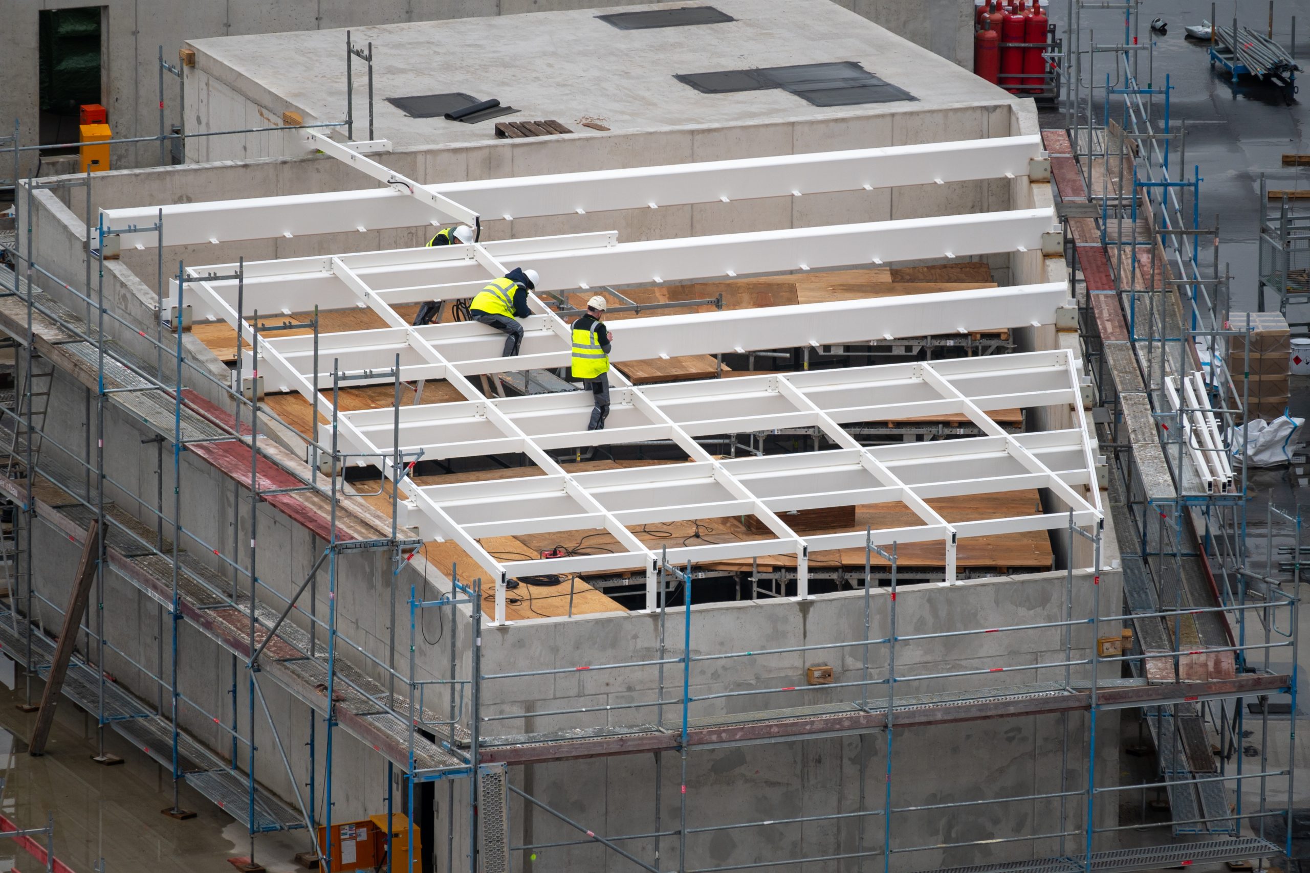 roofer preparing a construction for a light well on the roof of a commercial building.