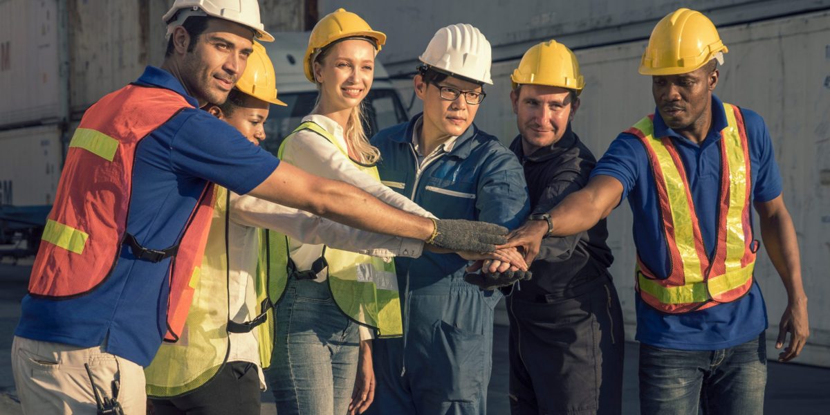 group of employees engineer meeting together show the best teamwork collaboration at container yard .membership join togetherness partnership and success concept